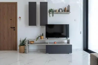 a living room with a television on a table at Taupe's 2-BR Apartment & Balcony in Larnaca in Livadhia