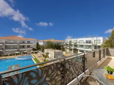 a balcony with a view of a pool and buildings at Mythical Sands AL14 in Paralimni