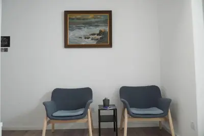 two chairs in a room with a picture on the wall at Athalassas corner in Strovolos