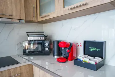 a kitchen counter with a microwave and a coffee maker at Armonia Seafront Studio in Limassol