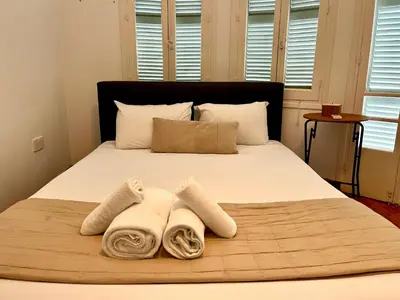 a bedroom with a bed with towels on it at Cozy Corner 2 Bdr Nicosia Center Platform 357 Ltd in Nicosia