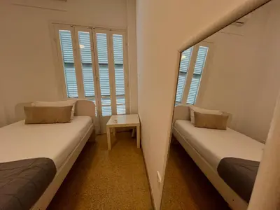 two beds in a small room with a mirror at Cozy Corner 2 Bdr Nicosia Center Platform 357 Ltd in Nicosia