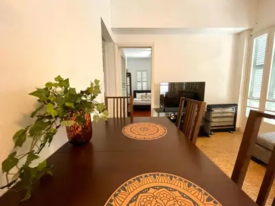 a dining room with a table and a living room at Cozy Corner 2 Bdr Nicosia Center Platform 357 Ltd in Nicosia