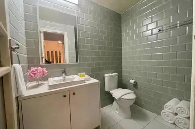 a bathroom with a sink and a toilet and a mirror at Cozy Corner 2 Bdr Nicosia Center Platform 357 Ltd in Nicosia