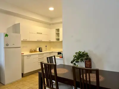 a kitchen with a table and chairs and a refrigerator at Cozy Corner 2 Bdr Nicosia Center Platform 357 Ltd in Nicosia