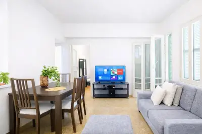 a living room with a couch and a table and a tv at Cozy Corner 2 Bdr Nicosia Center Platform 357 Ltd in Nicosia