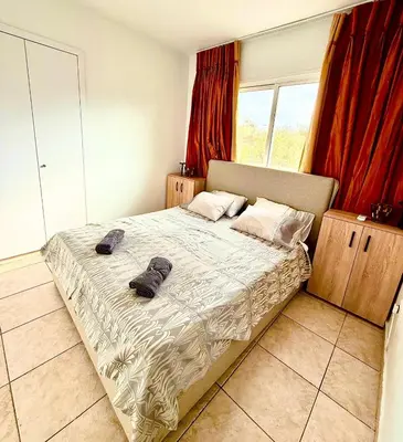 a bedroom with a bed with two shoes on it at Carisa rooms for holiday in Larnaka