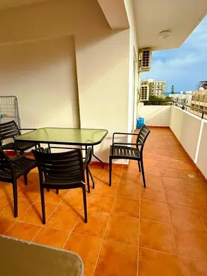 a balcony with a glass table and chairs on a roof at Carisa rooms for holiday in Larnaka