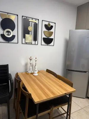 a kitchen with a wooden table and a refrigerator at Carisa rooms for holiday in Larnaka