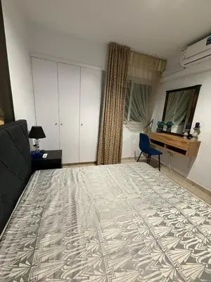 a living room with a bed and a couch and a window at Carisa rooms for holiday in Larnaka