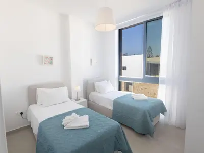 a white room with two beds and a window at Holiday Home Protaras Aqua Pearl Villa AQ16 by Interhome in Protaras