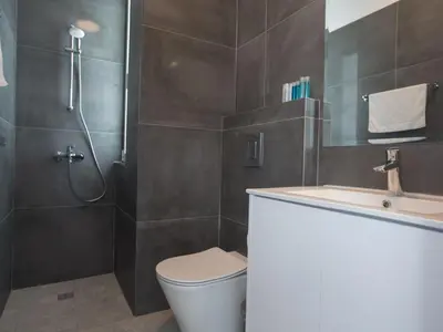 a bathroom with a shower and a toilet and a sink at Holiday Home Protaras Vie Bleu Villa mit Pool- im Zentrum by Interhome in Protaras