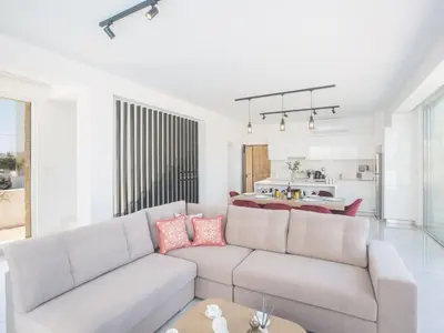 a living room with a couch and a table at Holiday Home Protaras Vie Bleu Villa mit Pool- im Zentrum by Interhome in Protaras