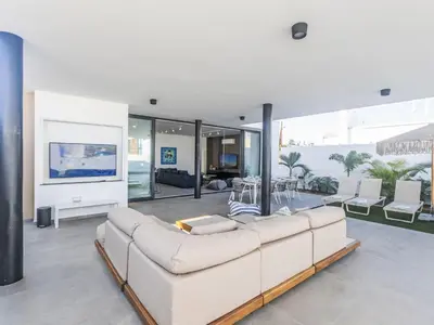 a living room with a white couch and a tv at Holiday Home Protaras Aqua Pearl Villa AQ18 mit Poolheizung by Interhome in Protaras