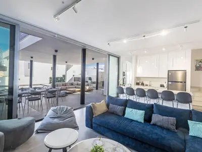a living room with a blue couch and a table at Holiday Home Protaras Aqua Pearl Villa AQ18 mit Poolheizung by Interhome in Protaras