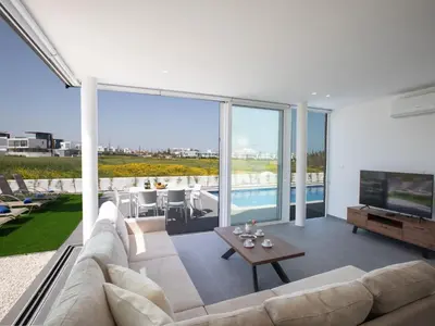 a living room with a couch and a television at Holiday Home Bleu Vie in Protaras by Interhome in Protaras