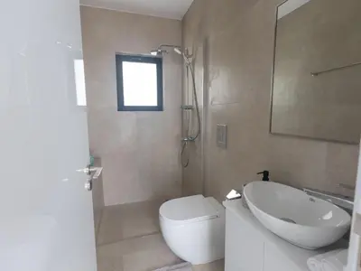 a bathroom with a toilet and a sink and a mirror at Holiday Home Protaras Aqua Pearl Villa AQ01 by Interhome in Protaras