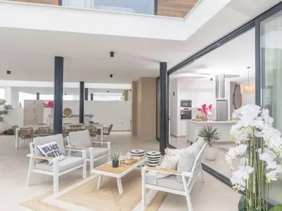 a living room with white chairs and a table at Holiday Home Protaras Aqua Pearl Villa AQ01 by Interhome in Protaras
