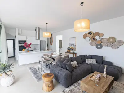 a living room with a couch and a table at Holiday Home Protaras Aqua Pearl Villa AQ01 by Interhome in Protaras