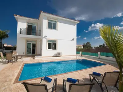 a villa with a swimming pool in front of a house at Holiday Home in Protaras mit privatem Parkplatz by Interhome in Protaras