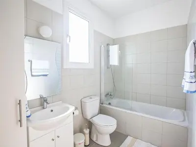 a bathroom with a toilet and a tub and a sink at Holiday Home in Protaras mit privatem Parkplatz by Interhome in Protaras
