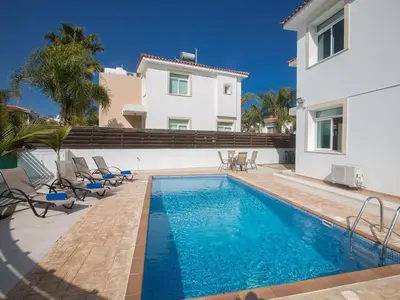 a swimming pool in front of a house at Holiday Home in Protaras mit privatem Parkplatz by Interhome in Protaras