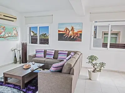 a living room with a couch and a table at Holiday Home in Protaras mit privatem Parkplatz by Interhome in Protaras