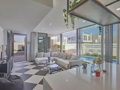 a living room with a couch and a table at Holiday Home Protaras Almaria Villa ALM08 by Interhome in Protaras