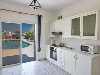 a kitchen with a view of a swimming pool at Holiday Home Protaras Villa mit Pool am Strand der Fig Tree Bay by Interhome in Protaras
