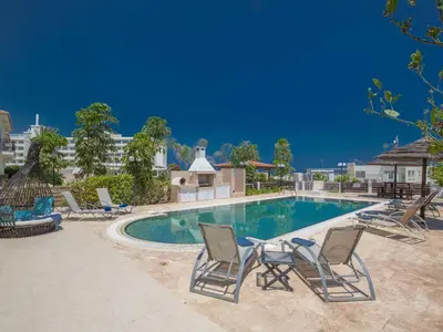 a swimming pool with lounge chairs and a swimming pool at Holiday Home Protaras Villa mit Pool am Strand der Fig Tree Bay by Interhome in Protaras