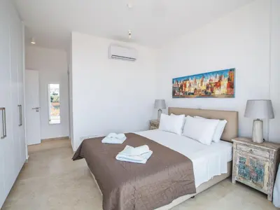 a bedroom with a bed with two towels on it at Holiday Home 3-Schlafzimmer-Villa mit privatem Pool im Zentrum by Interhome in Protaras