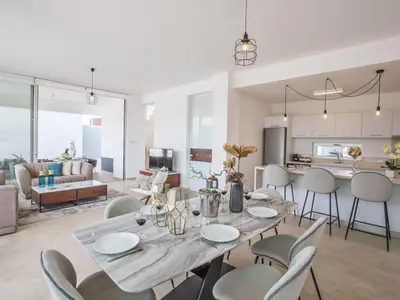 a dining room and living room with a table and chairs at Holiday Home 3-Schlafzimmer-Villa mit privatem Pool im Zentrum by Interhome in Protaras