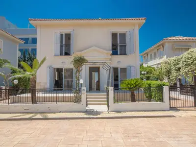 a white house with a black fence at Holiday Home in Protaras mit privatem Parkplatz by Interhome in Protaras