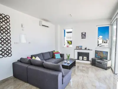 a living room with a couch and a tv at Holiday Home Protaras Perle Villa PE15 by Interhome in Protaras