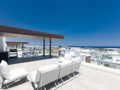 a patio with white chairs and a view of the ocean at Holiday Home Protaras Olivine Villa OL9 by Interhome in Protaras