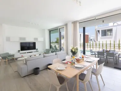 a living room with a table and a couch at Holiday Home Protaras Olivine Villa OL9 by Interhome in Protaras