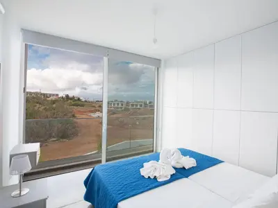 a bedroom with a large window with towels on a bed at Holiday Home 2-Schlafzimmer-Villa mit Pool- Dachgarten- Meerblick by Interhome in Protaras
