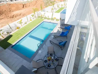 an overhead view of a swimming pool with chairs and a table at Holiday Home Protaras Olivine Villa mit Pool und einem Dachgarten by Interhome in Protaras