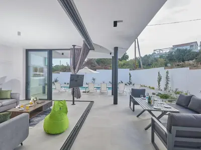 a living room with couches and tables at Holiday Home Protaras Elite Perle Villa EP3C by Interhome in Protaras