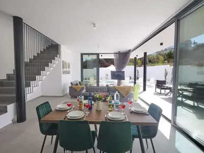 a dining room and living room with a table and chairs at Holiday Home Protaras Elite Perle Villa EP3C by Interhome in Protaras