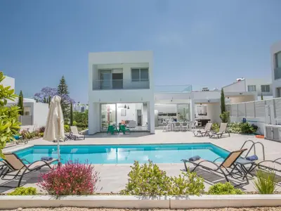 a villa with a swimming pool and chairs at Holiday Home Protaras Greco Villa CCV2 by Interhome in Protaras