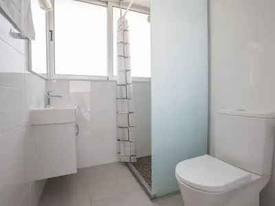 a white bathroom with a toilet and a window at Holiday Home Protaras Greco Villa CCV2 by Interhome in Protaras