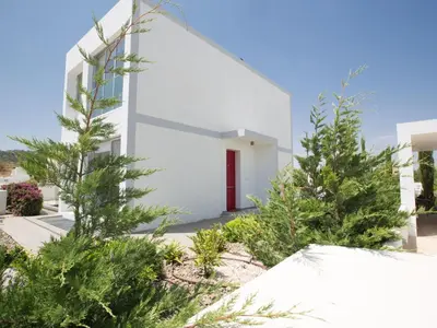a white building with trees in front of it at Holiday Home Protaras Greco Villa CCV2 by Interhome in Protaras
