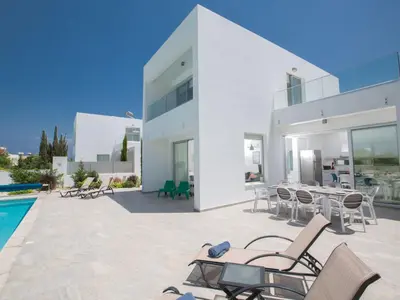 a large white house with a patio and a swimming pool at Holiday Home Protaras Greco Villa CCV2 by Interhome in Protaras