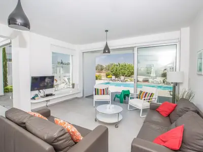 a living room with a couch and a pool at Holiday Home Protaras Greco Villa CCV2 by Interhome in Protaras