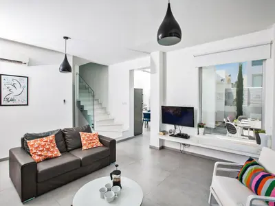 a living room with a couch and a tv at Holiday Home Protaras Greco Villa CCV2 by Interhome in Protaras