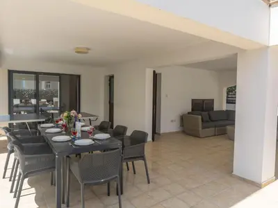 a dining room with a table and chairs at Holiday Home Ferienvilla für 10 Personen in Protaras by Interhome in Protaras