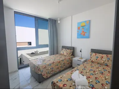 a bedroom with two beds and a window at Holiday Home Protaras Aqua Pearl Villa AQ12 by Interhome in Protaras