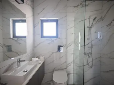 a bathroom with a toilet and a sink and a shower at Holiday Home Protaras Aqua Pearl Villa AQ12 by Interhome in Protaras