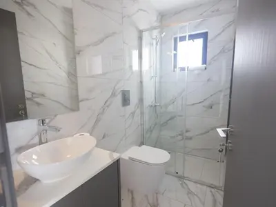 a white bathroom with a toilet and a sink at Holiday Home Protaras Aqua Pearl Villa AQ12 by Interhome in Protaras